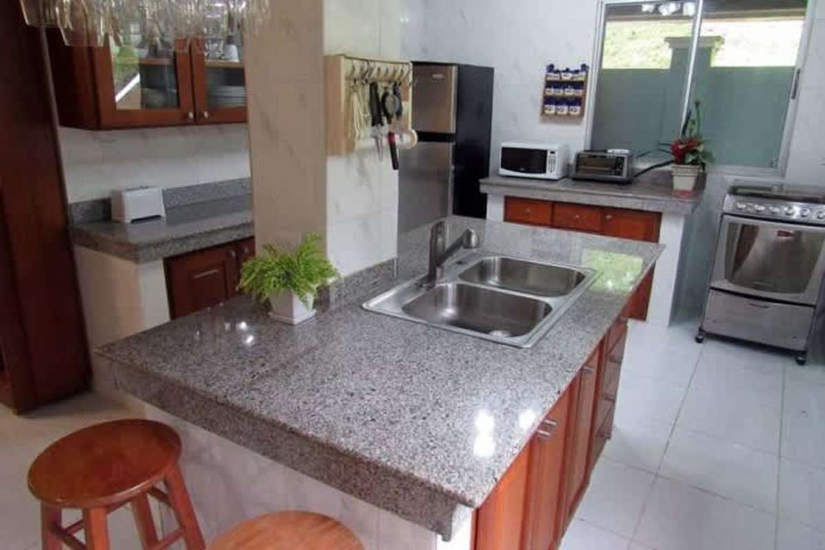 Covered balcony overlooking garden and mountain landscape Cerro Azul Panama