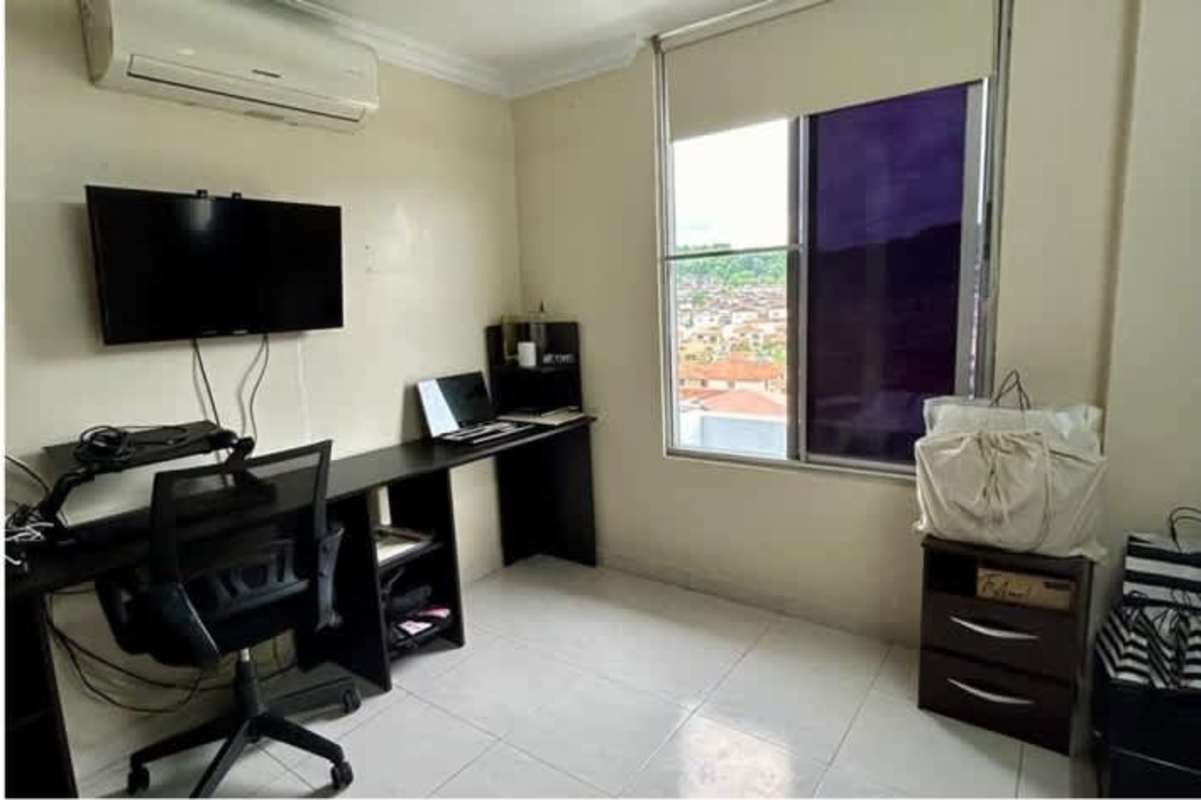Modern home office setup with large window and city views in PH Altos del Condado Altos de Panamá