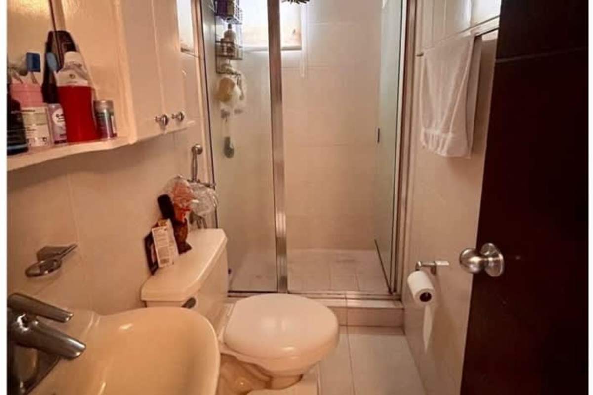 Contemporary bathroom with glass enclosed shower, white fixtures in PH Altos del Condado Panama City