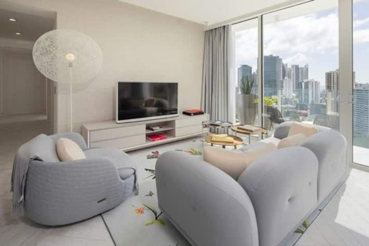 Modern open plan kitchen and dining area with island and high-end appliances Empire Residences Obarrio Panama