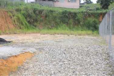 Cleared uneven terrain with soil mounds and fencing Puerto Pilón Colón Panama