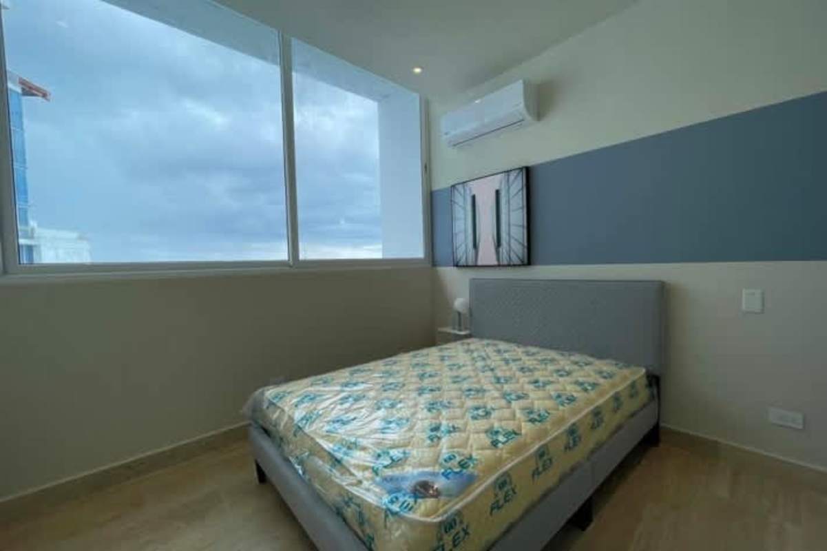 Elegant master bedroom with floor-to-ceiling windows showcasing Pacific Ocean in PH Ocean House Costa del Este Panama