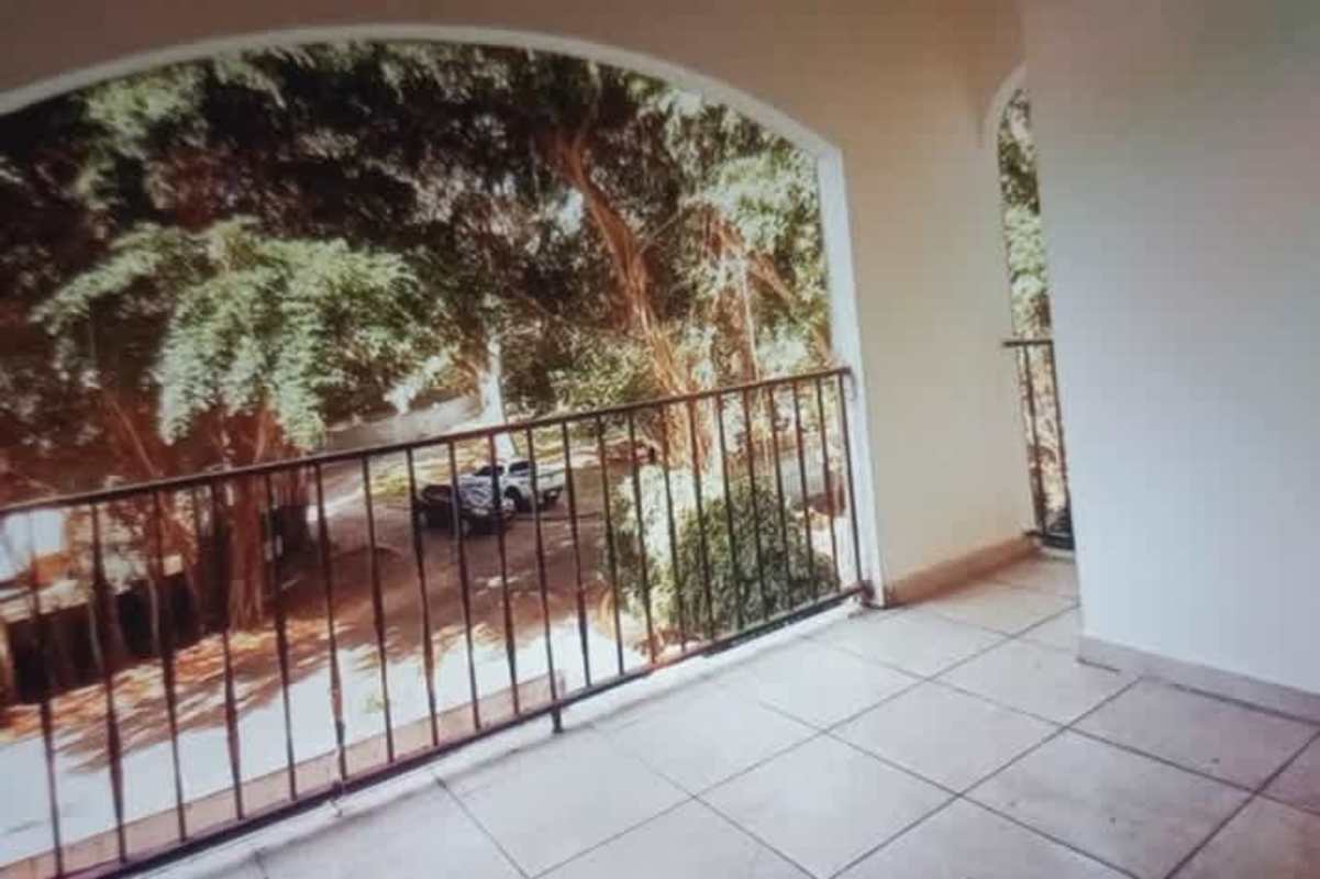 Large covered terrace with decorative arches overlooking canal, trees and bridge PH Amador Hills Panama