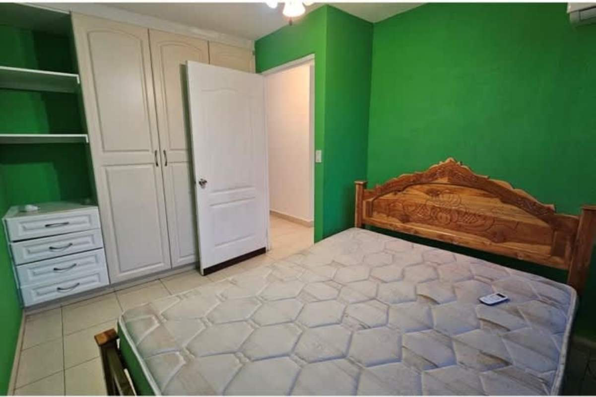 Indoor staircase with wrought iron railing, orange wall accent, PH Dorado Lakes Panama