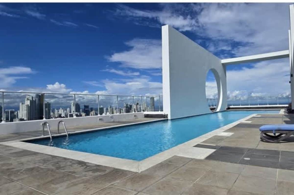 Bright living room with glass doors to oceanview balcony PH Destiny Avenida Balboa Panama City