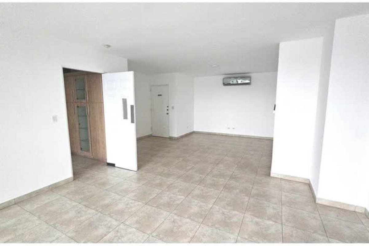 Spacious living room with ceramic tiled floor, large window, balcony access at PH Mystic Point Panama City