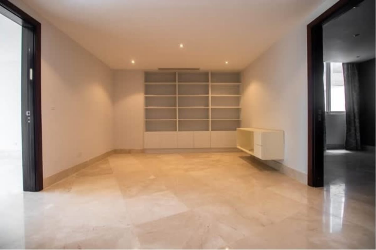 Large empty marble floor living room built-in shelves PH Punta Paitilla Panama City