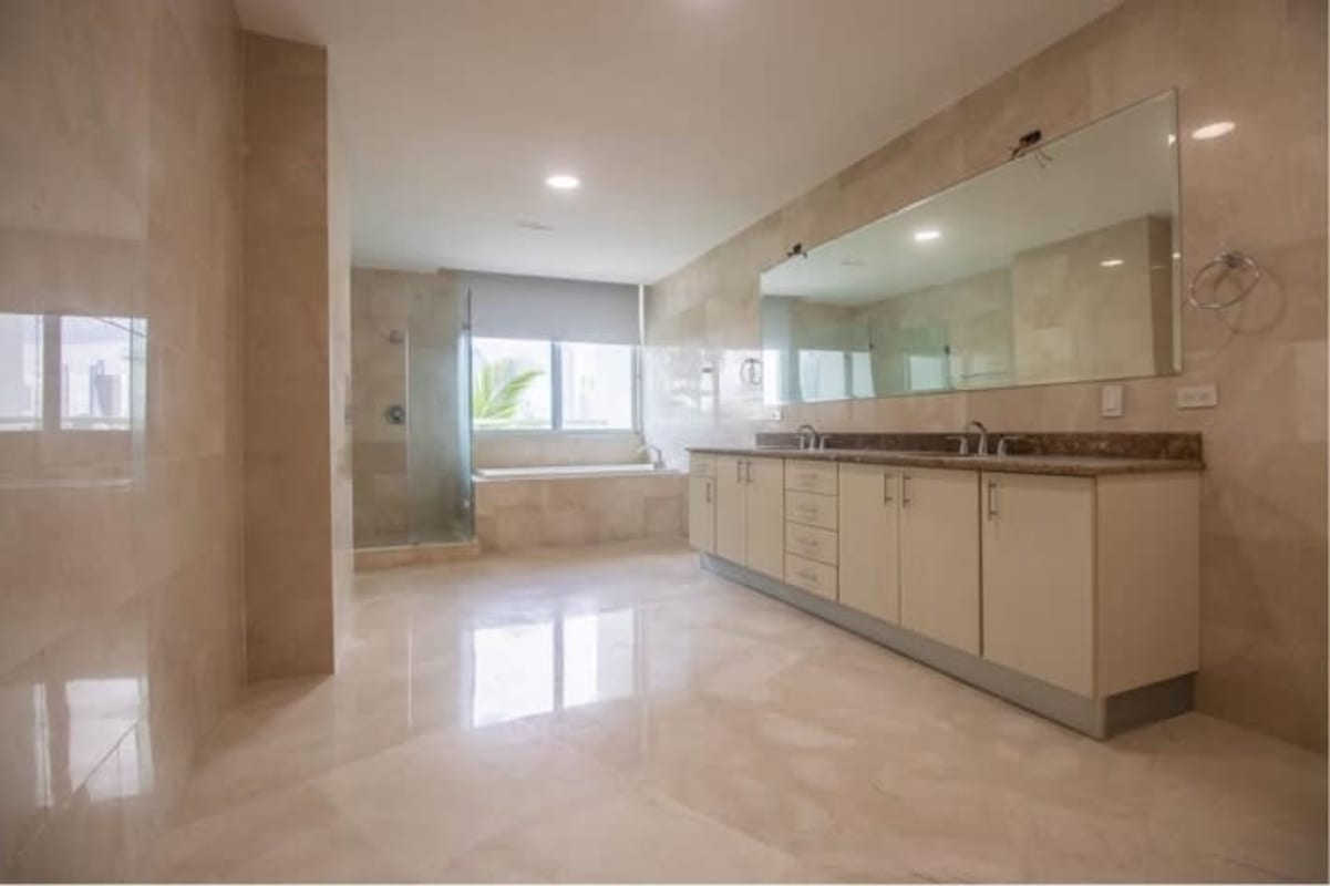 Modern bathroom with double sink, marble walls, large shower & jacuzzi in PH Punta Paitilla Panama City luxury apartment