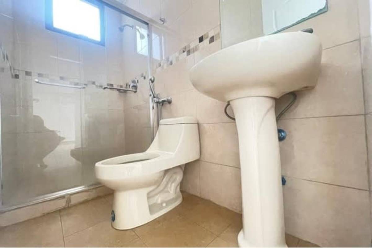 Contemporary bathroom with glass shower enclosure and pedestal sink in PH Vía Romana Panama City