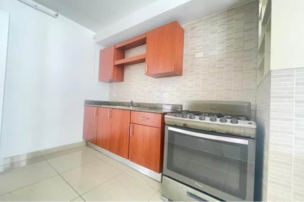 Kitchen with granite counters, wood cabinets, gas stove in PH Vía Romana Panama