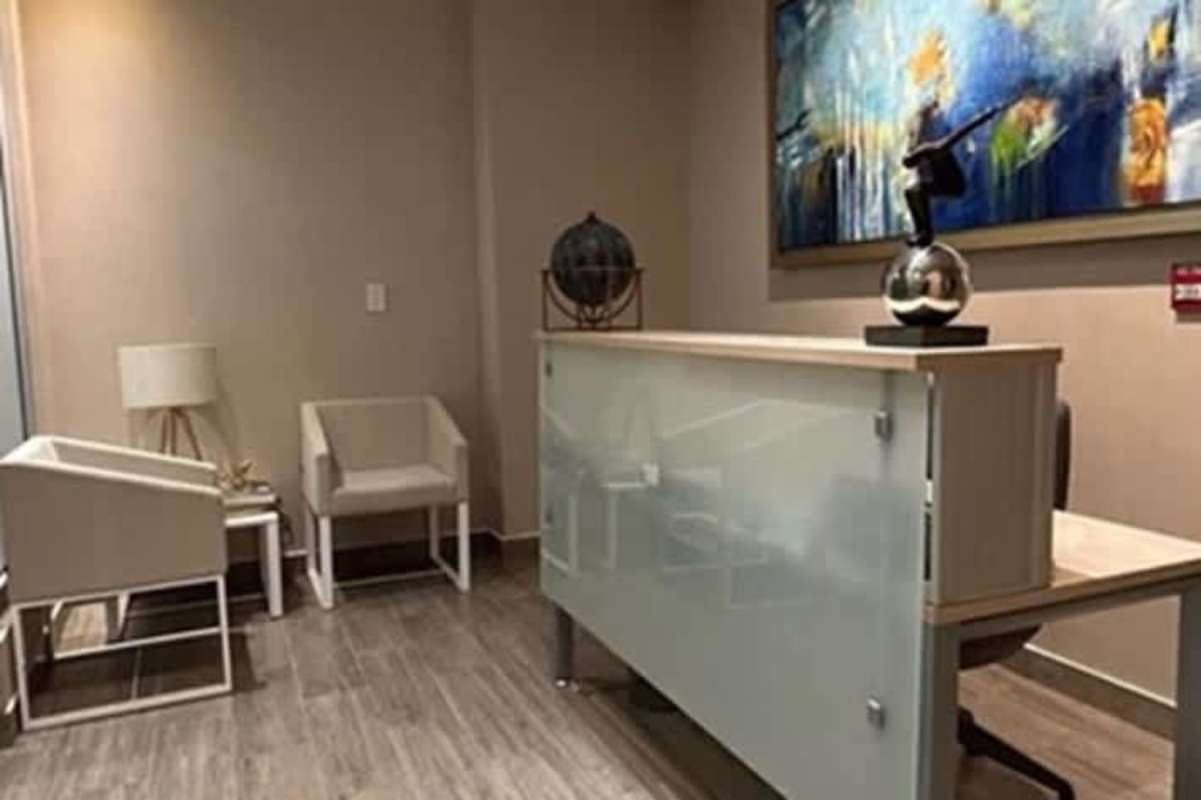 Shared coworking area with modern desks, natural light, and minimalistic design in PH BICSA Tower Obarrio Panama