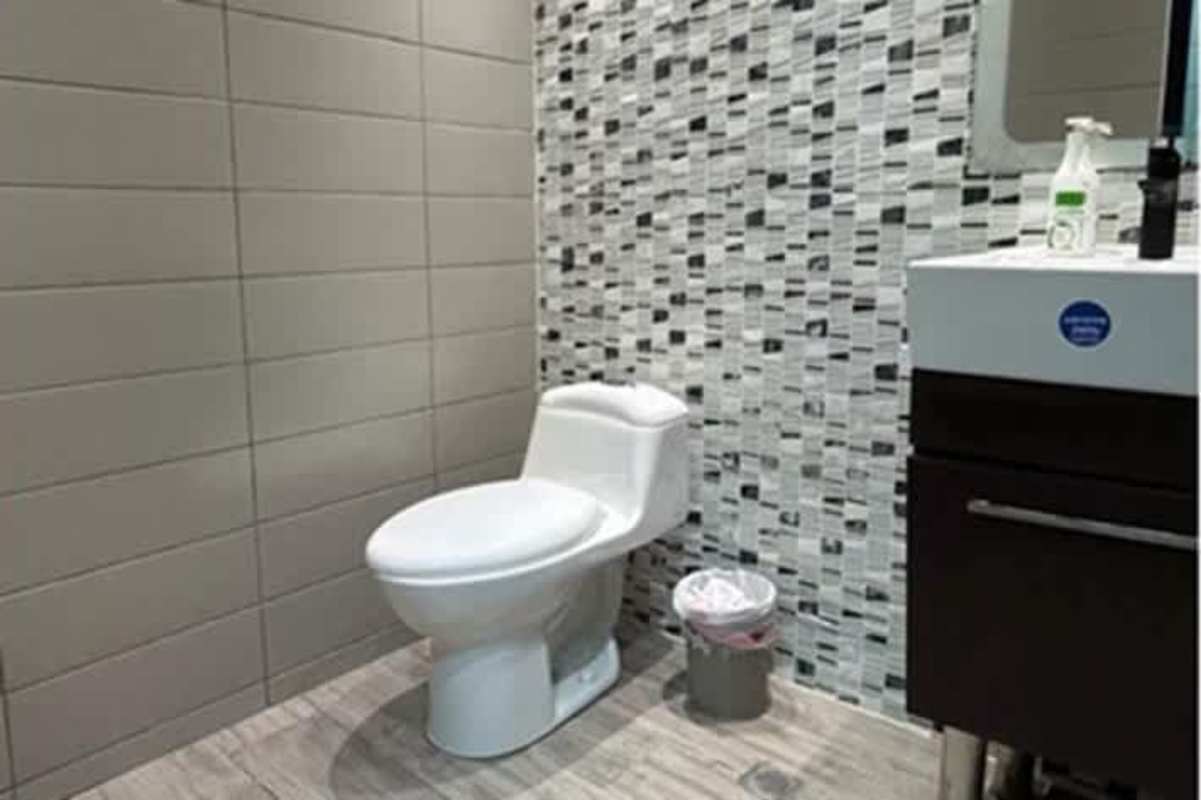 Contemporary office bathroom with mosaic wall tiles and white vanity PH BICSA Financial Center Panama