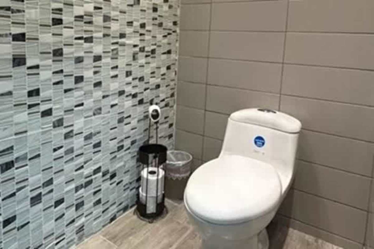 Modern office with desks facing large window with ocean and skyline views PH BICSA Tower Obarrio