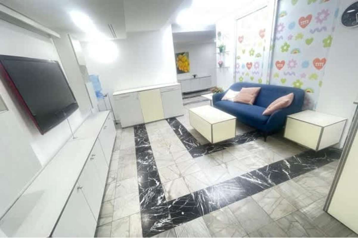 Spacious open-plan office with modern tile floors, recessed lighting PH BICSA Tower