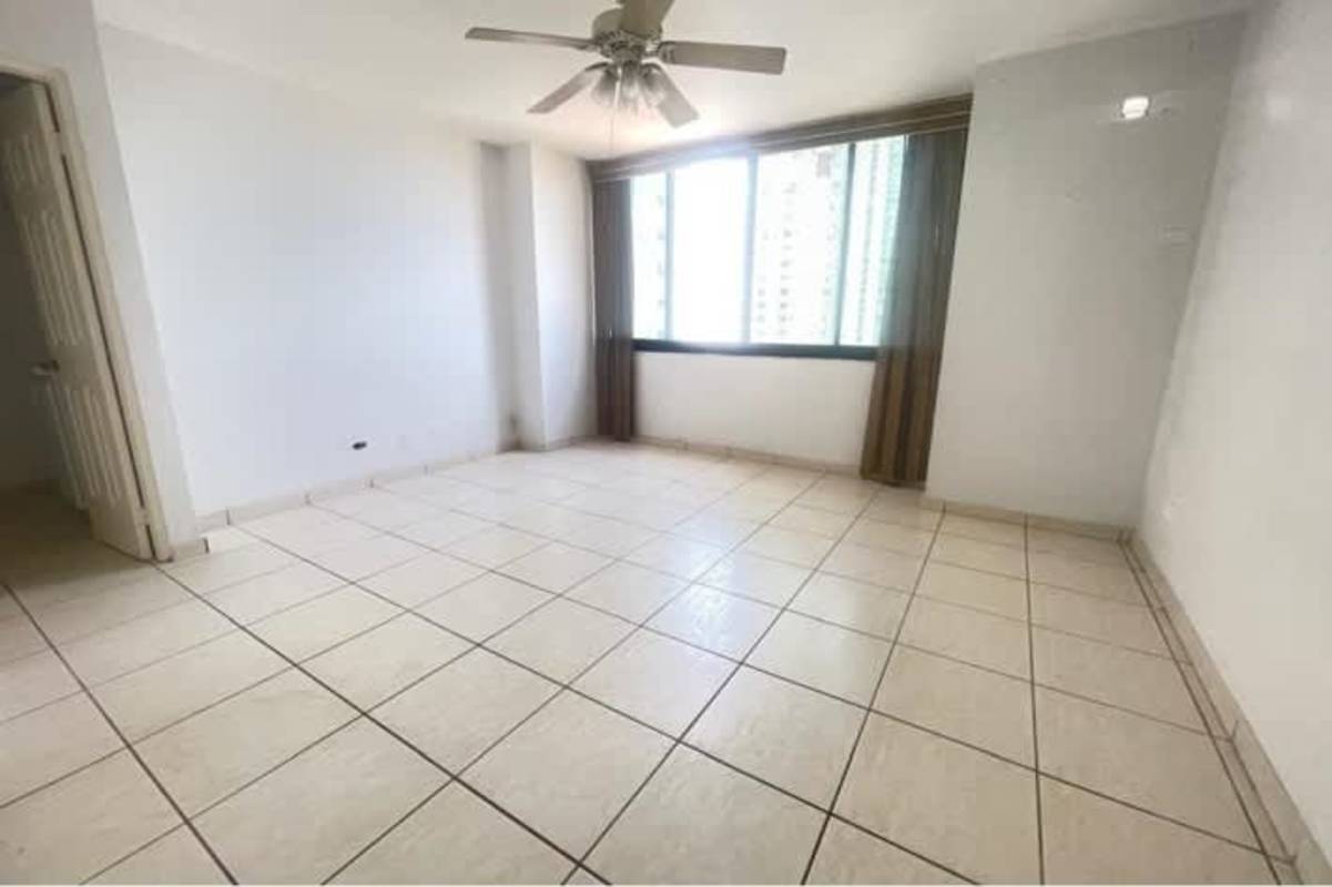 Bright living room with ceiling fan and big window Panama apartment