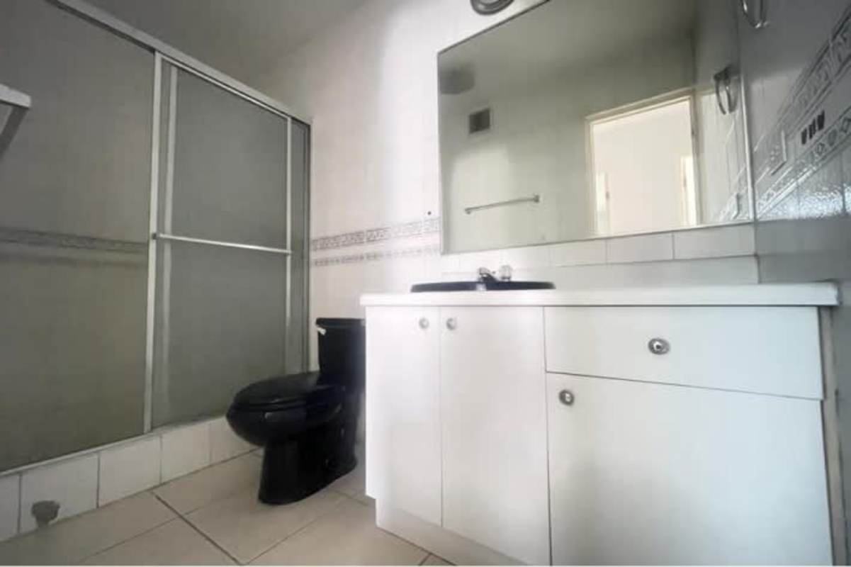 Bathroom with modern fixtures, sliding shower doors at PH San Francisco Tower