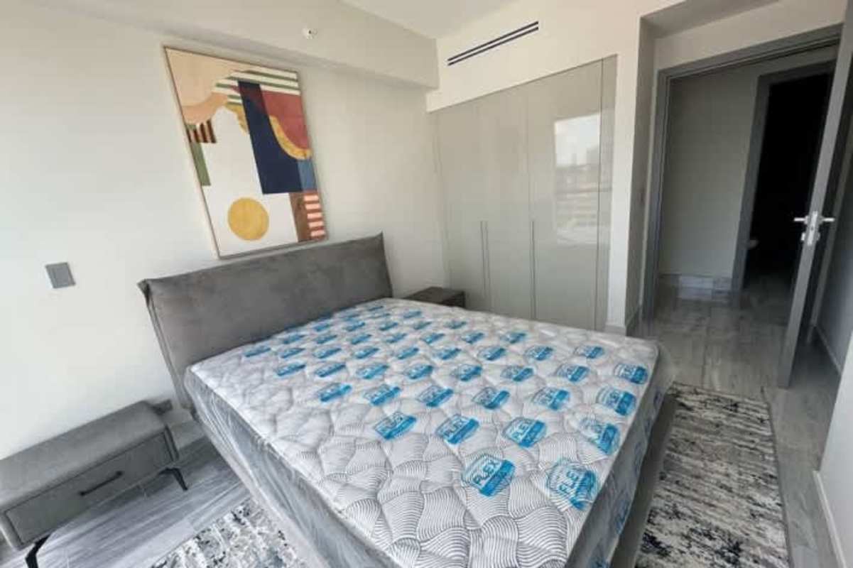 Contemporary kitchen with dark island, built-in appliances, city views in Yoo Panama