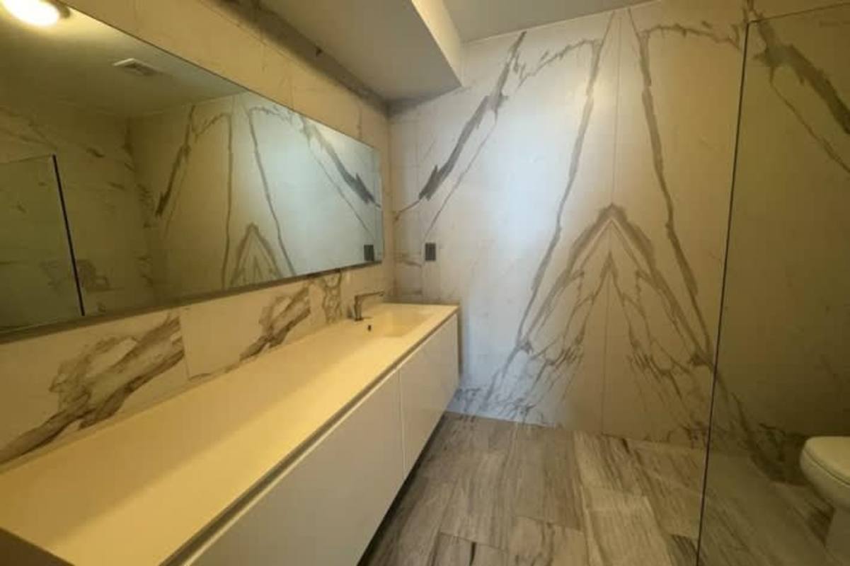 Furnished bedroom with large windows, king bed, Bella Vista skyline view PH BICSA Panama