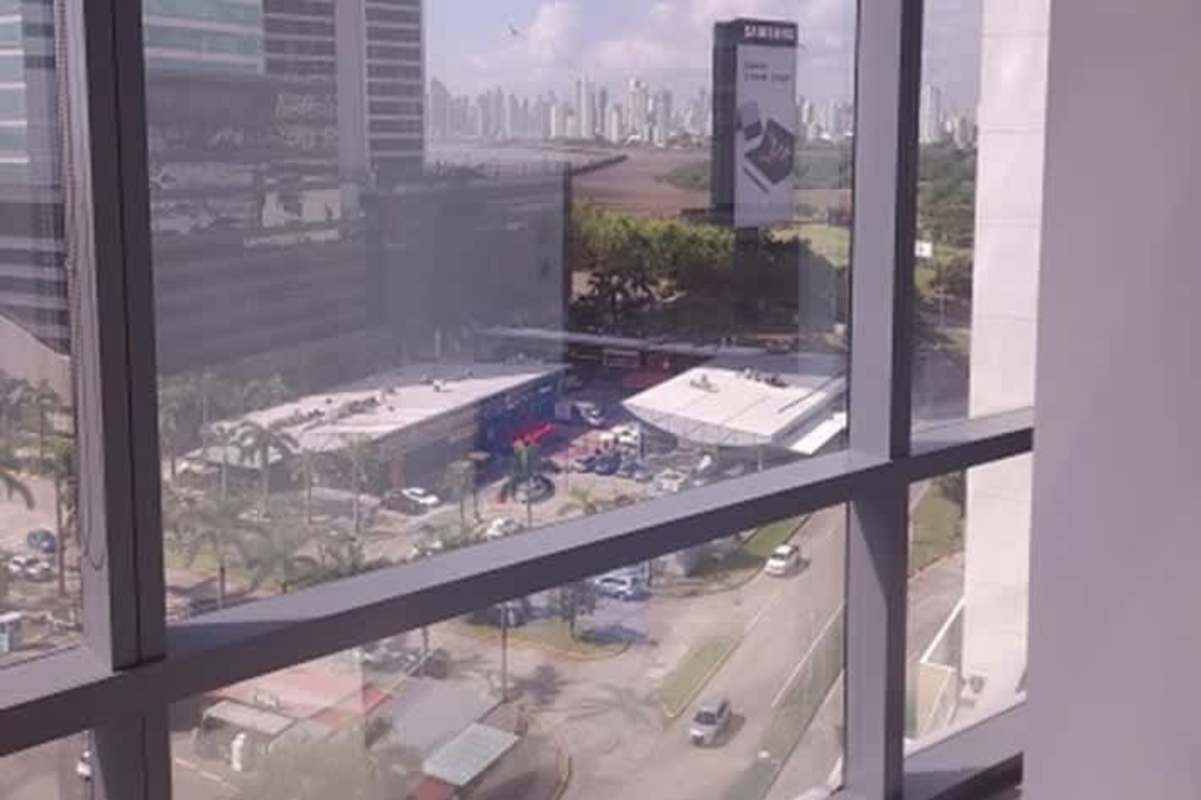 Tall commercial skyscraper with sleek curved glass in Panama business hub