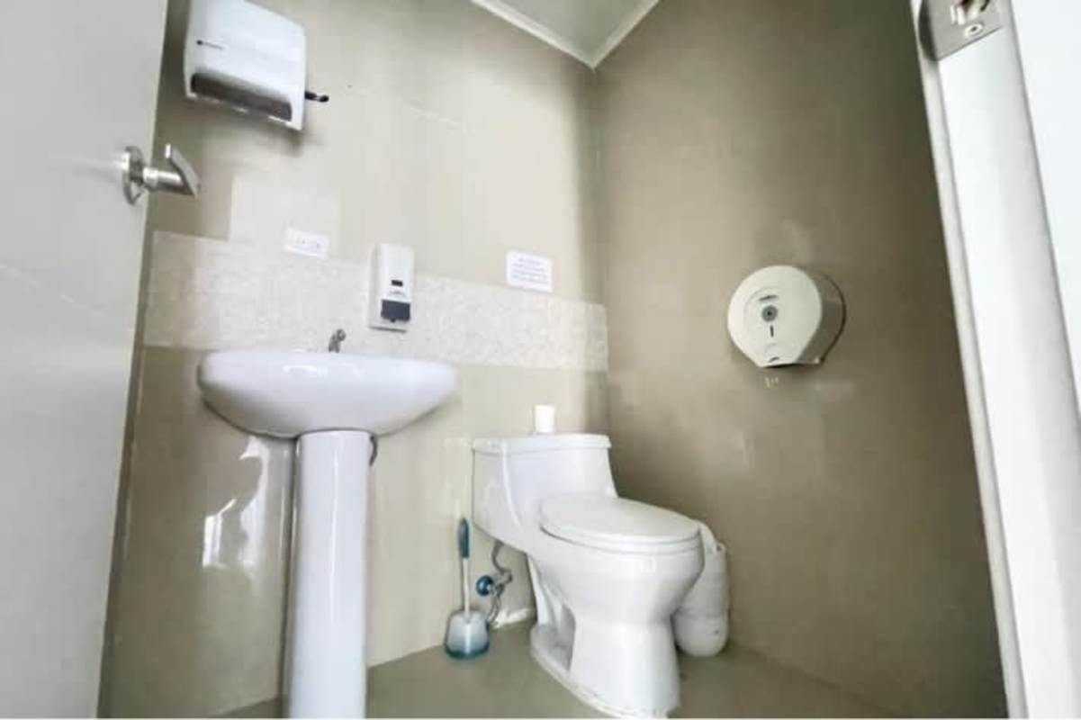 Modern commercial restroom with sink and toilet PH BICSA Tower