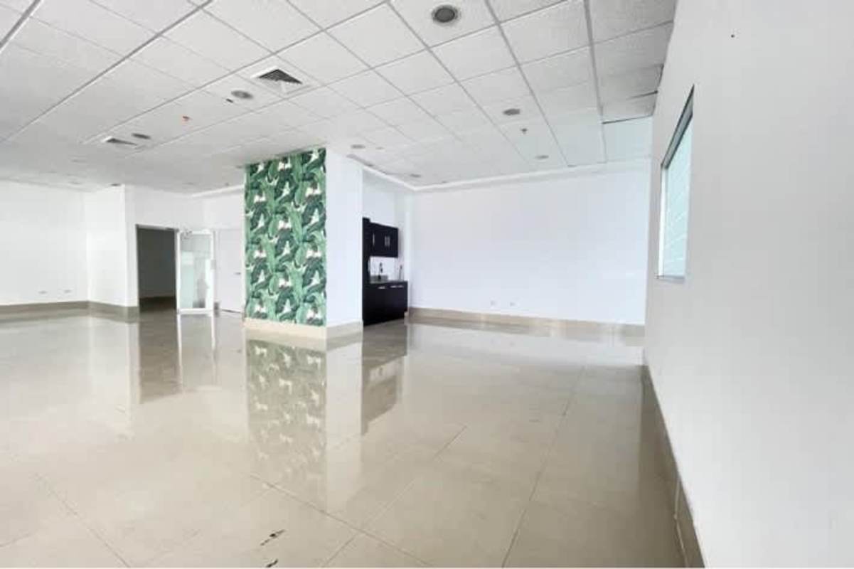 Open plan office with kitchenette, tiled floor and leaf accent wall in PH BICSA Tower