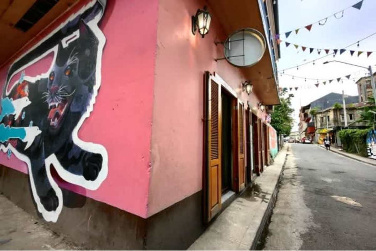 Rustic industrial dining hall with string lights colonial Casa Alba Casco Viejo Panama