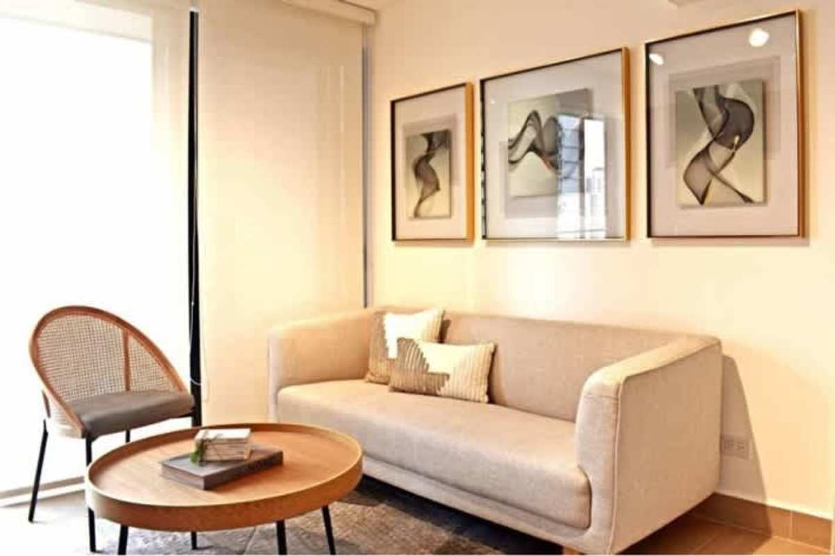 Modern living room with large windows and balcony city view at PH BeLiving San Francisco