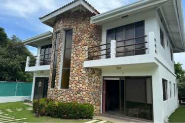 Covered porch with patio furniture and laundry space at duplex house in Playa Palmar beach community Panama