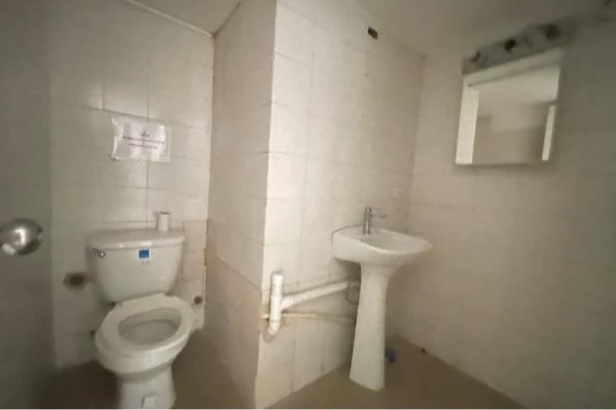 Simple bathroom with pedestal sink and toilet in commercial unit PH Diamond Tower Obarrio Panama City