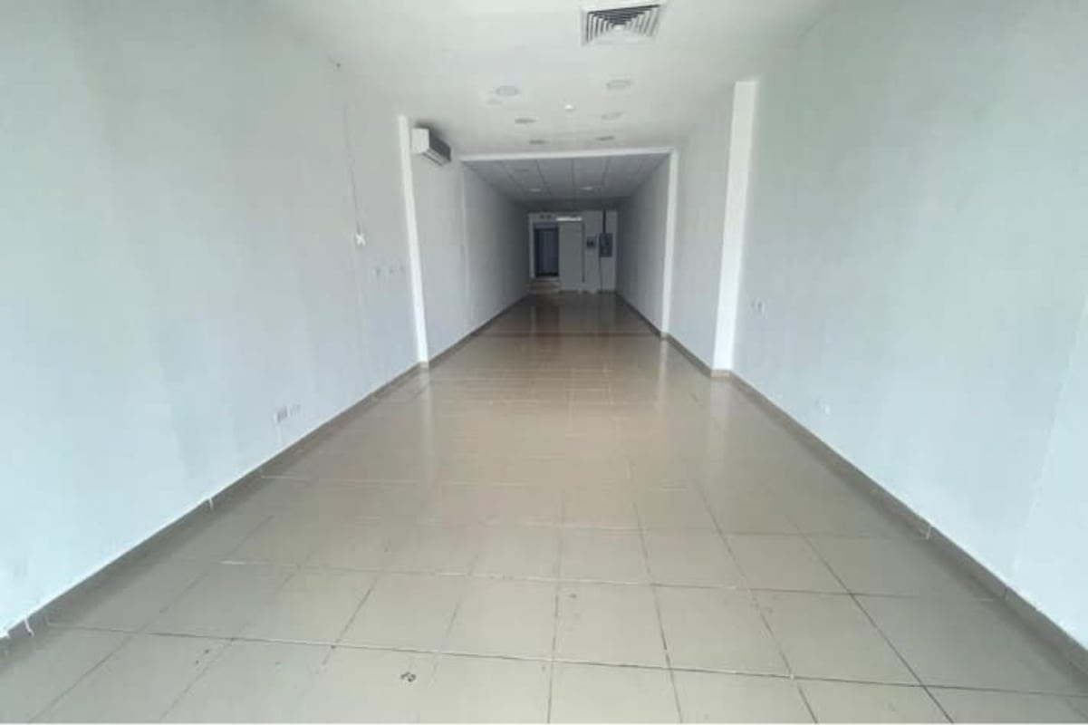 Empty open commercial space with tiled floor and white walls inside PH Diamond Tower in Obarrio Panama