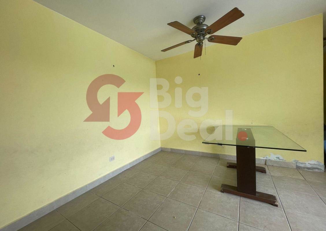 Dining or office space with ceiling fan and yellow accent wall in PH Green Bay Panama City