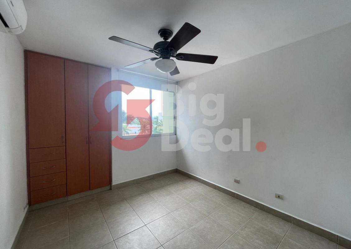 Living room with ceiling fan, large windows and city view in PH Green Bay Costa del Este Panama City