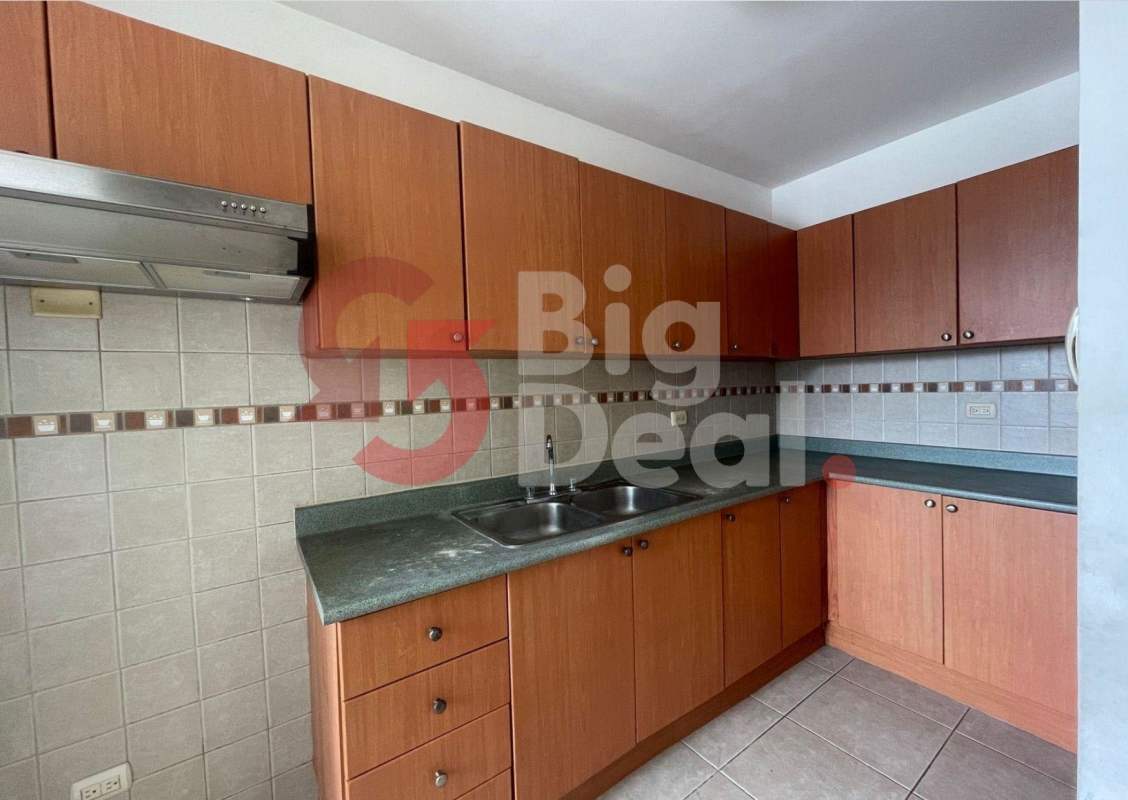 Kitchen with granite countertops, tile backsplash, wooden cabinets in PH Green Bay Costa del Este Panama