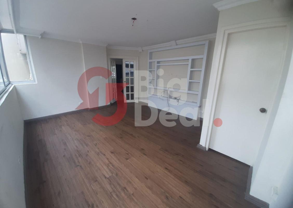 Spacious living room with built-in shelving, large windows, wooden floors in PH La Concha Marbella Panama