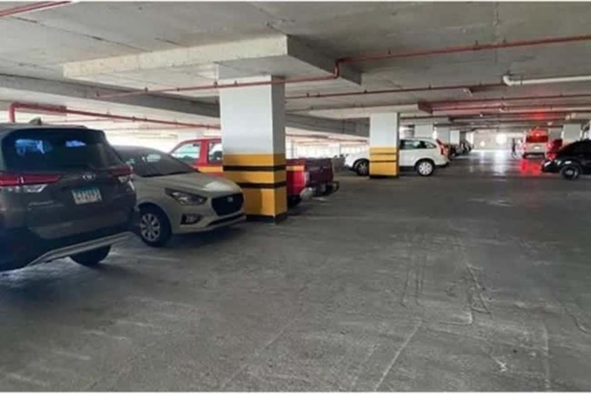 Spacious indoor parking garage area at Crystal Plaza Mall with multiple parked vehicles