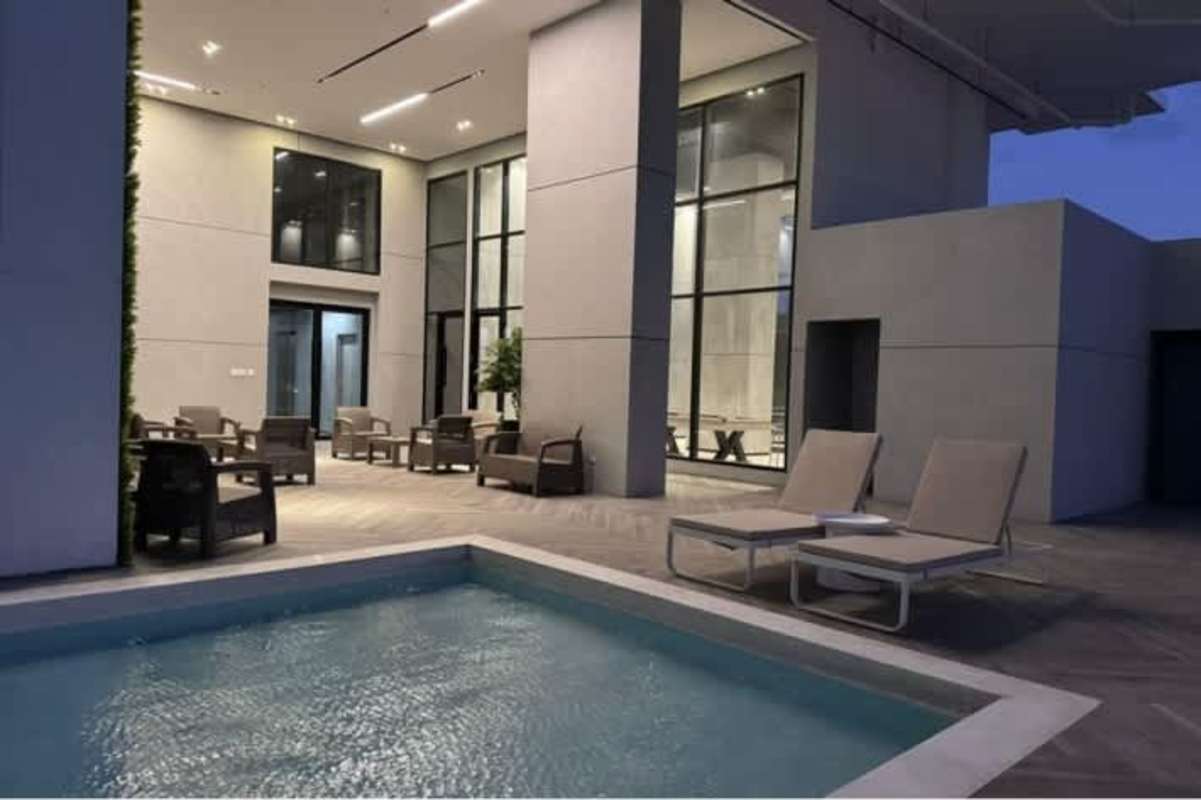 Bright bedroom with city views and large window at PH Center Point Tower 12 de Octubre Panama