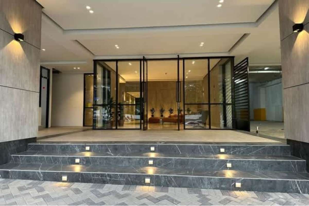 Living-dining room with large windows and balcony city view in PH Center Point Tower Panama City