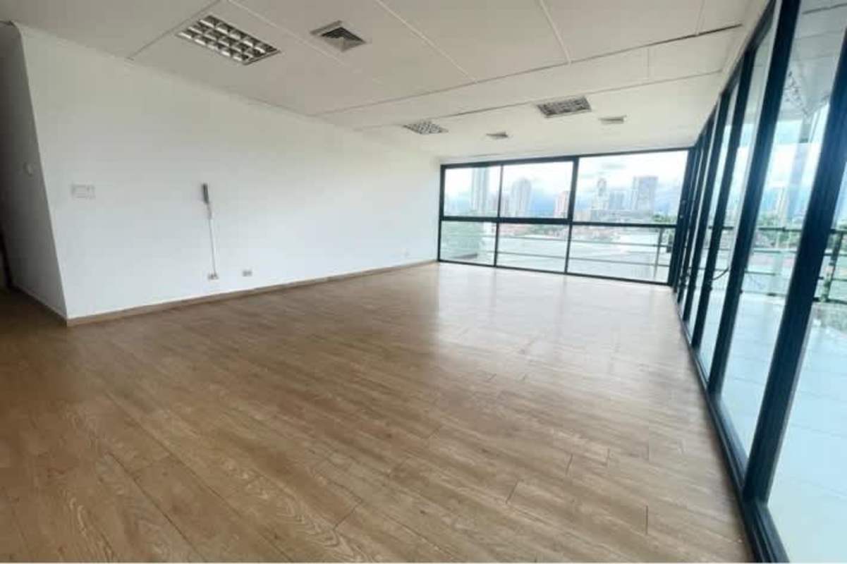 Empty office with tile floors, grey walls and window city skyline view PH BICSA Tower Panama