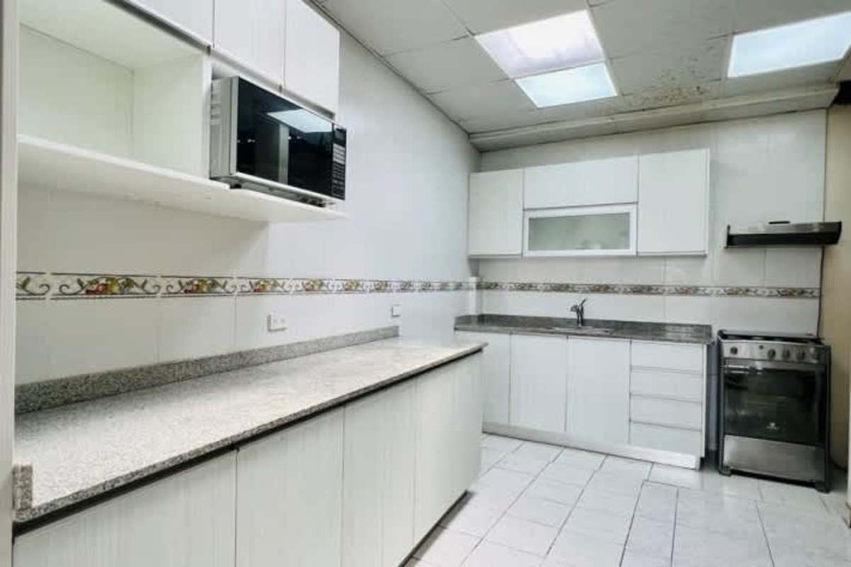 Living and dining space with tile floors ceiling fan in Villas de Vizcaya Panama