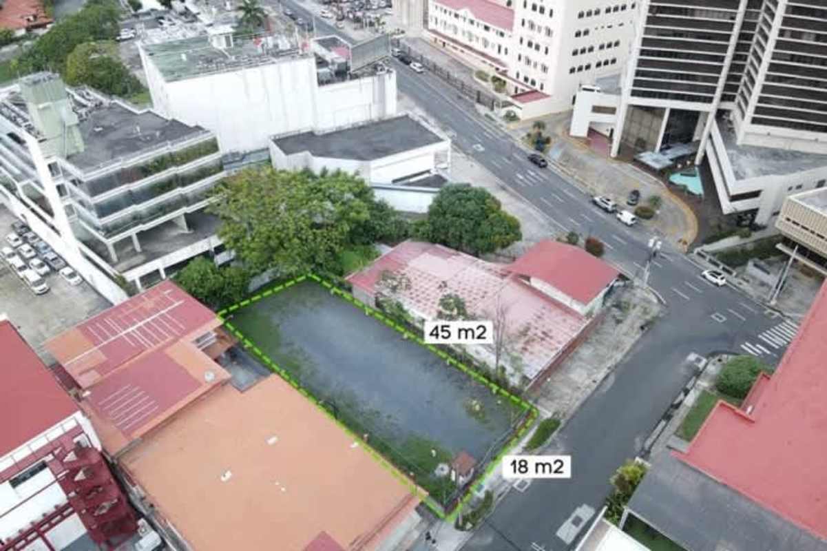 Empty corner lot with surrounding urban commercial buildings ready for development in Obarrio Banking District Panama City