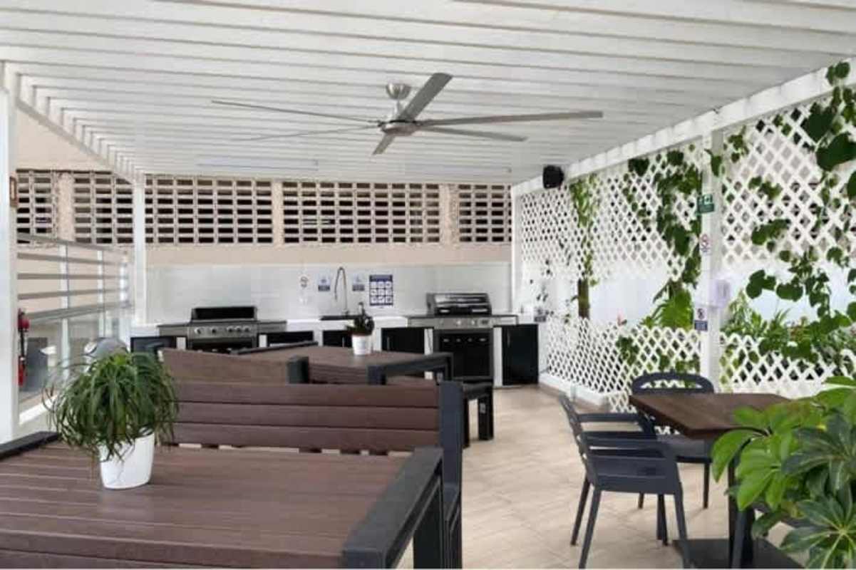 Covered outdoor BBQ area and garden lounge at Pacific Village Punta Pacifica Panama City