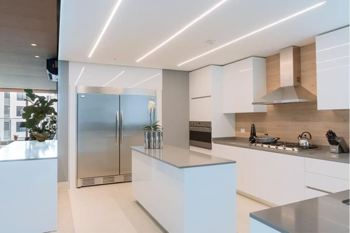 Modern kitchen with white cabinets island stainless appliances Coco del Mar Panama