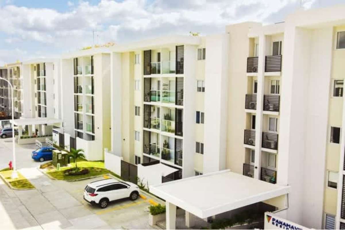Bright living dining room with sliding glass door and Scandinavian decor PH Panama Viejo Residences Panama City