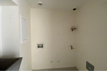 Kitchen with granite countertop and modern cabinetry in PH Midrise Woodlands apartment Panama Pacifico