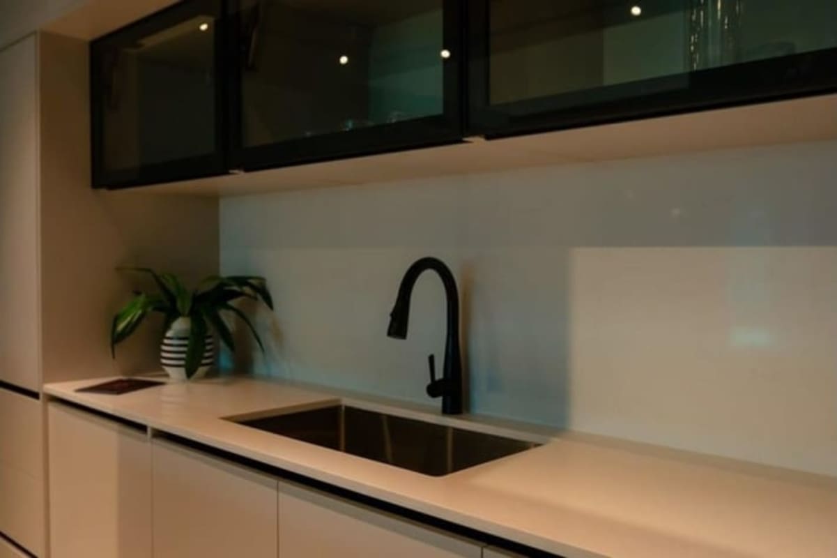 Modern open kitchen with bar seating and appliances, Uptown Condo Panama City