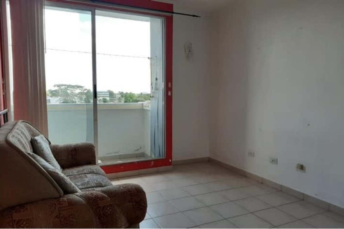 Living area with tile floor, sliding door to balcony in budget-friendly apartment Juan Díaz Panama City