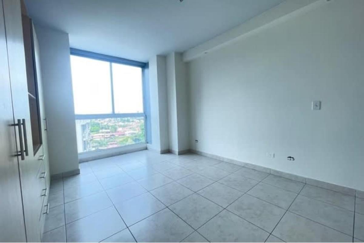 Bright apartment bedroom with city view window and built-in closet Betania Panama