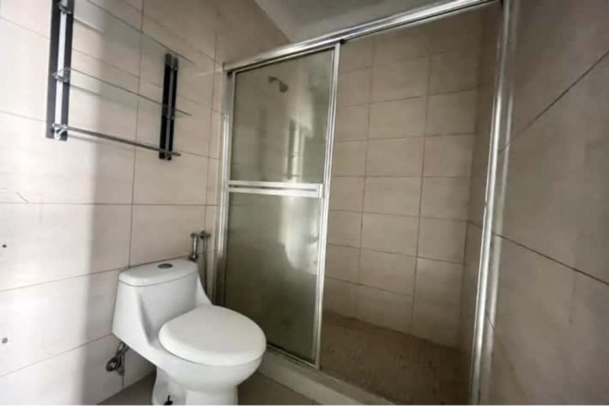 Minimalist bathroom with glass shower bidet toilet and pedestal sink PH El Cangrejo Bella Vista