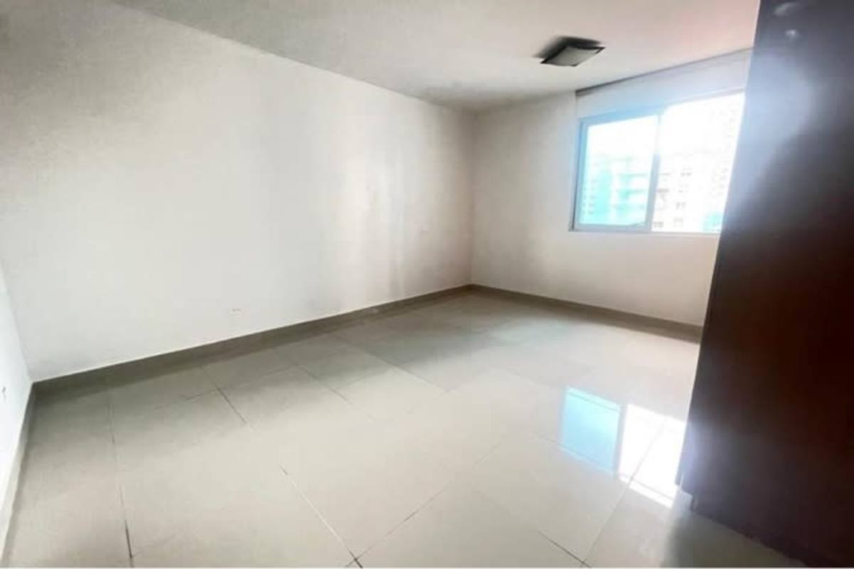 Bright bedroom with large window and built-in wooden wardrobe PH El Cangrejo Bella Vista Panama