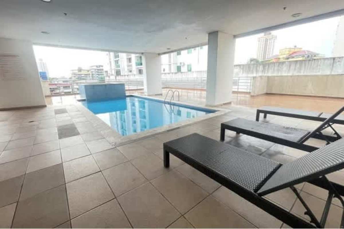 Covered pool with panoramic city views and relaxation area PH El Cangrejo Panama City